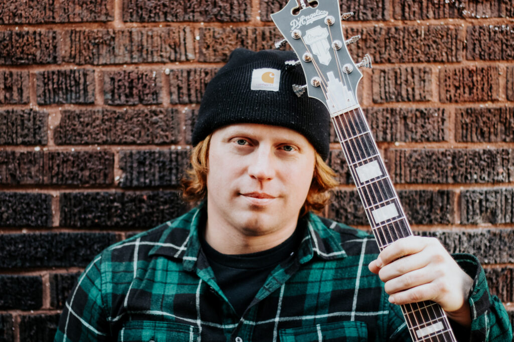 Josh Oddity with his Guitar